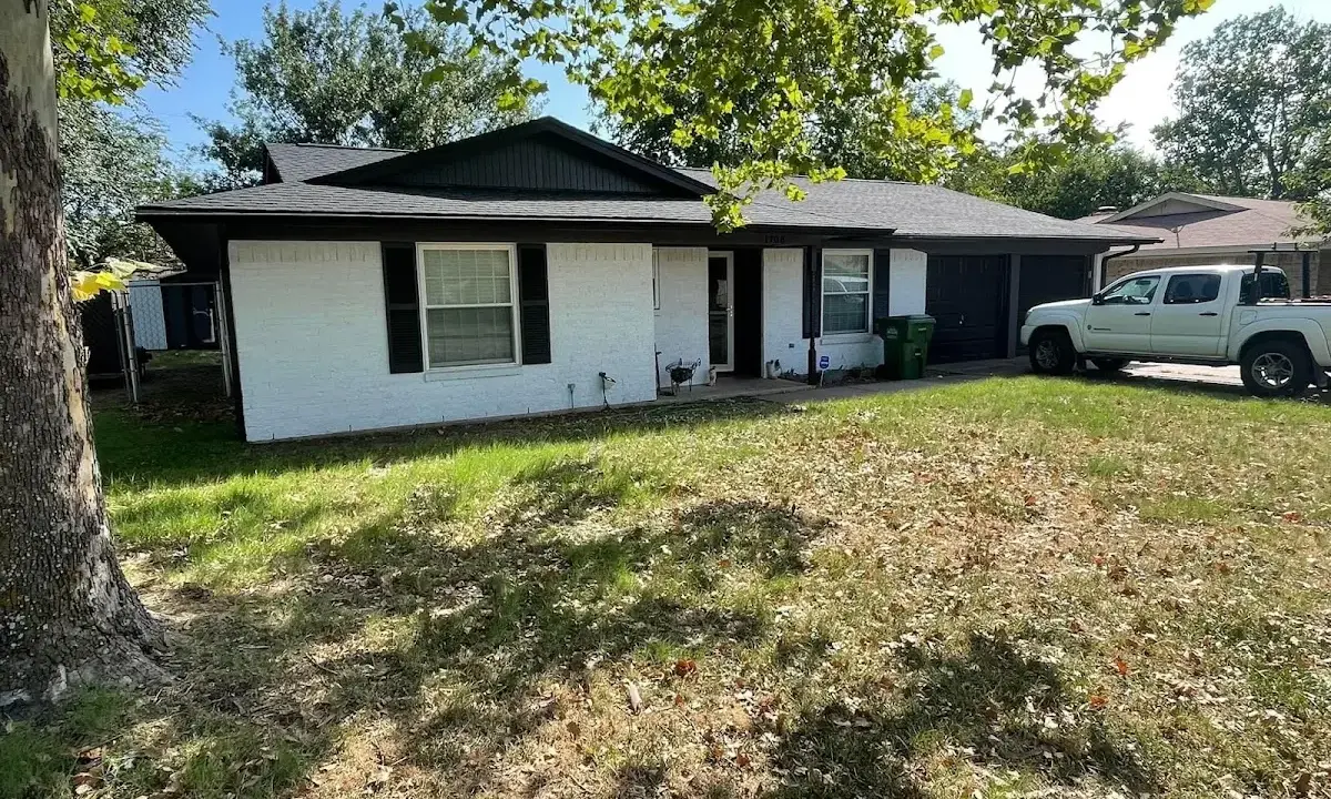 Professional roofing crew working on a residential roof in Calverton